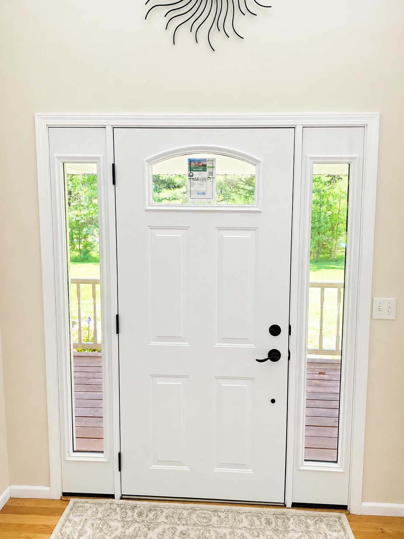 White front door with glass side panels, pairing well with Replacement Windows Wisconsin views.